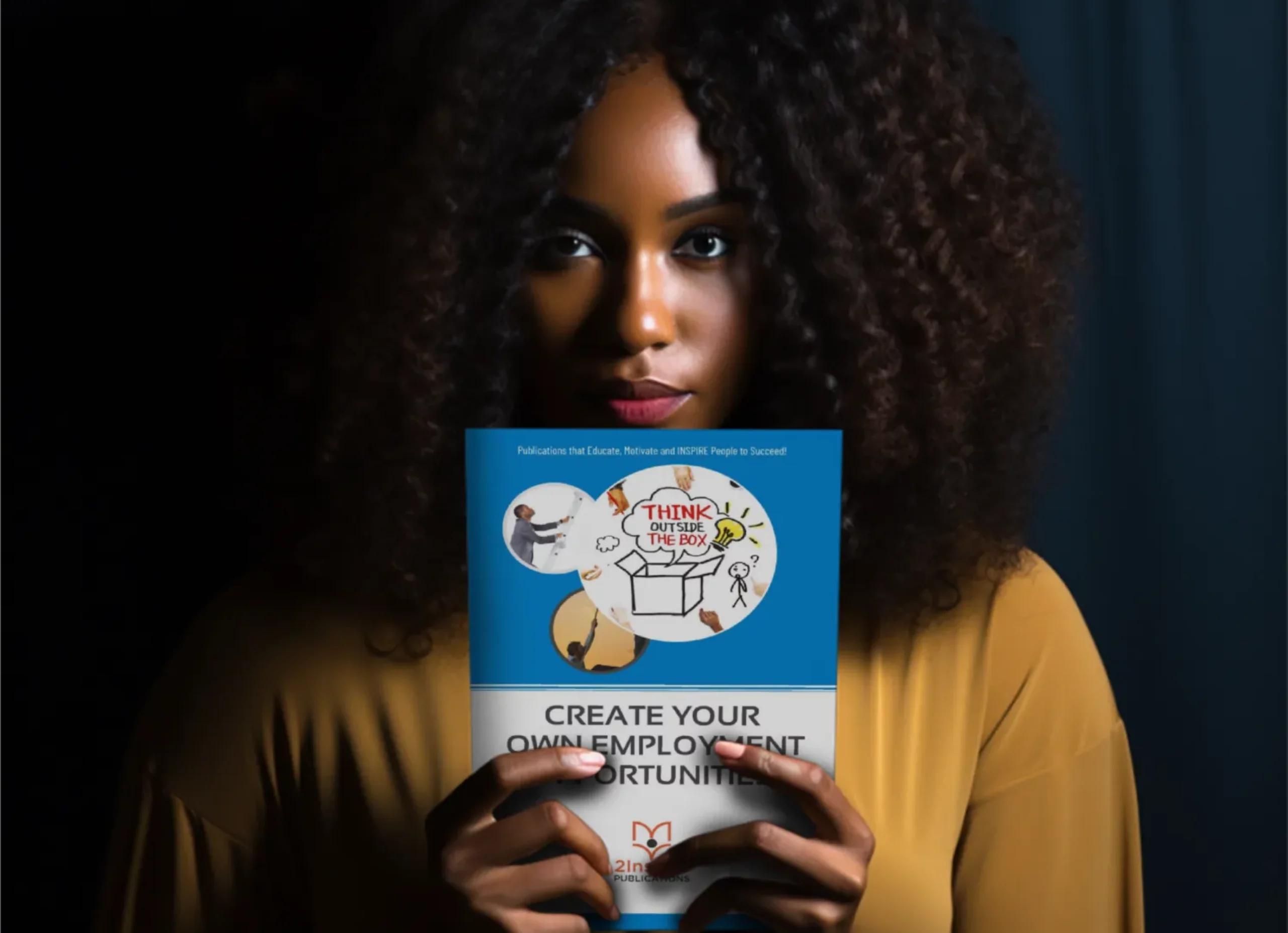 Woman holding a financial literacy book titled “Create Your Own Employment Opportunities” with focused expression.
