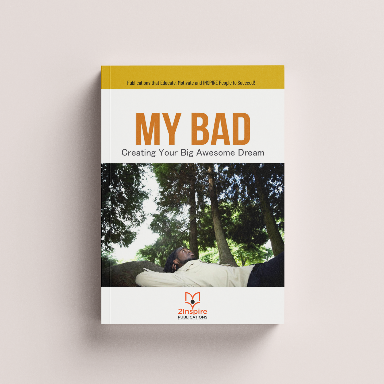 Book cover titled My BAD: Creating Your Big Awesome Dream featuring a man lying on a rock looking up, surrounded by tall trees and sunlight.